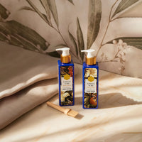 Two Forest Noir skincare products on a wooden surface with a leafy background